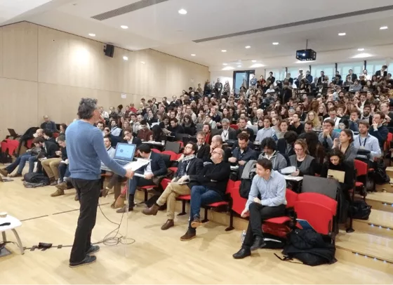 A lecture in a packed auditorium at the Paris School of Economics